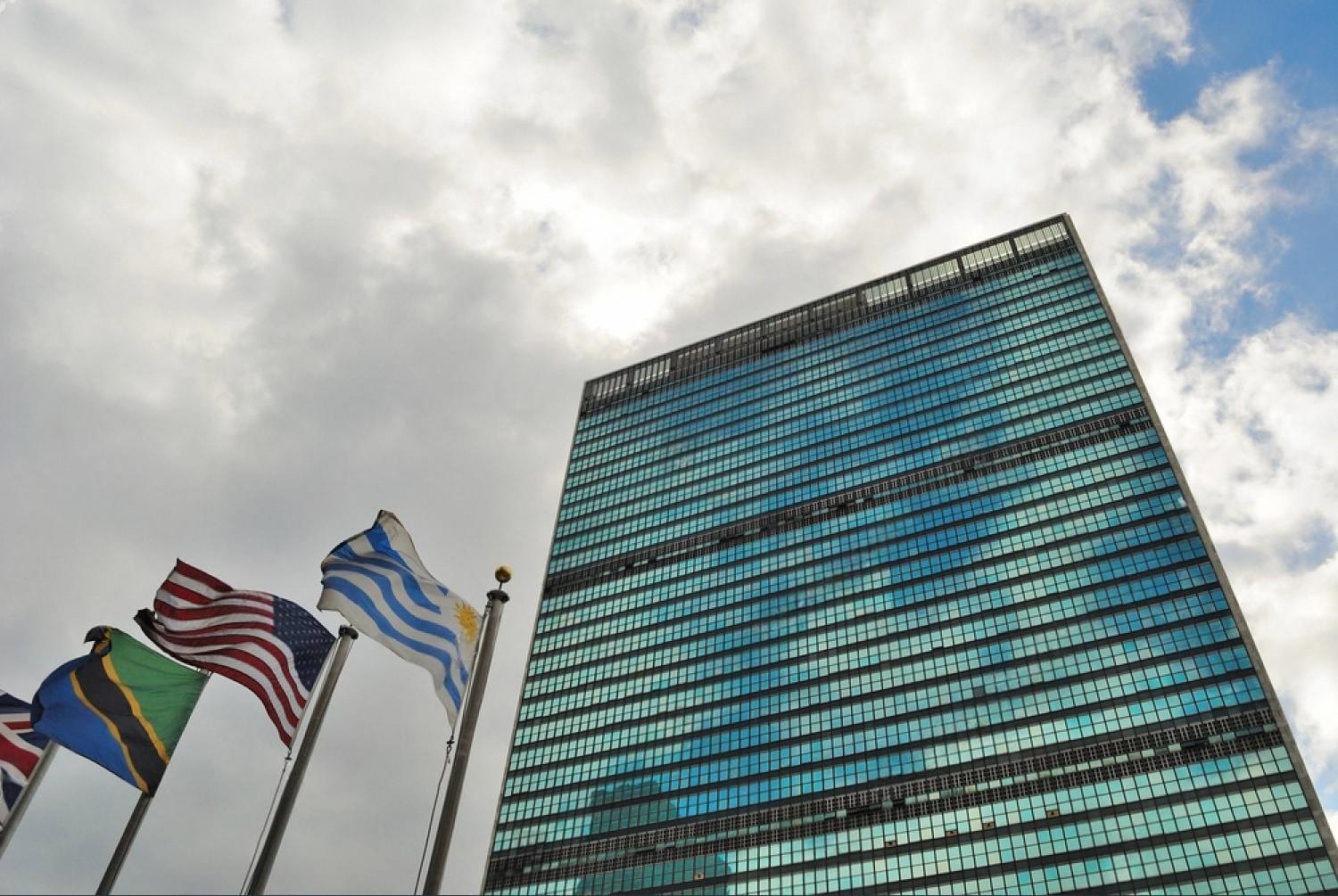 Flags of member states outside a United Nations building, symbolising the geopolitical environment UAE businesses operate in